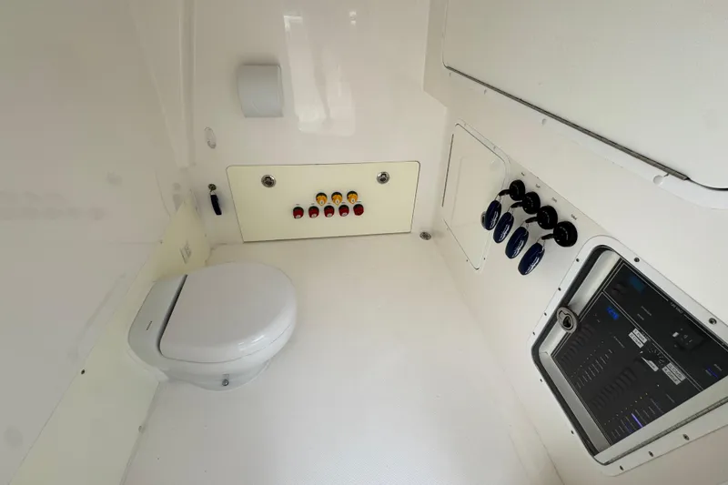 Slide: The Image of 2020 Invincible 35 Catamaran interior with toilet and control panel. - 36