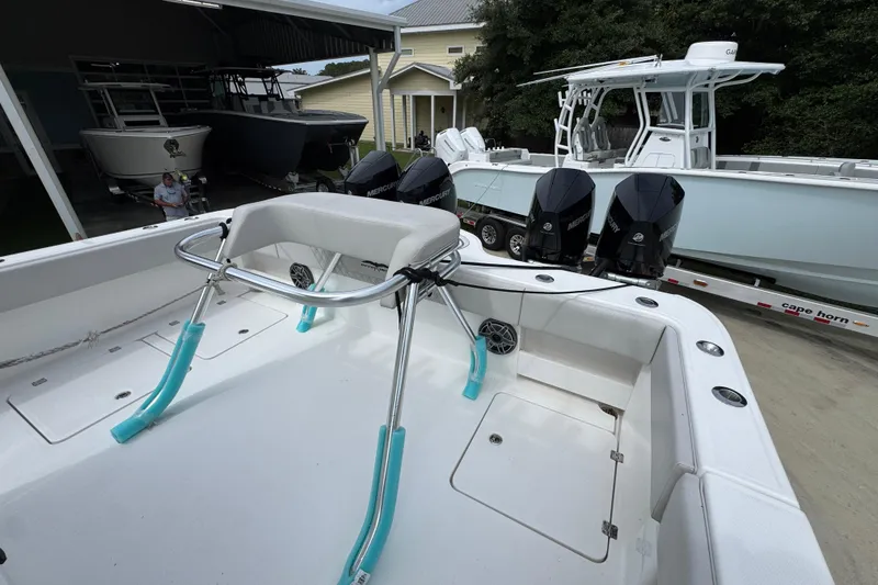 Slide: The Image of 2020 Invincible 35 Catamaran with triple Mercury engines in a boatyard setting. - 40