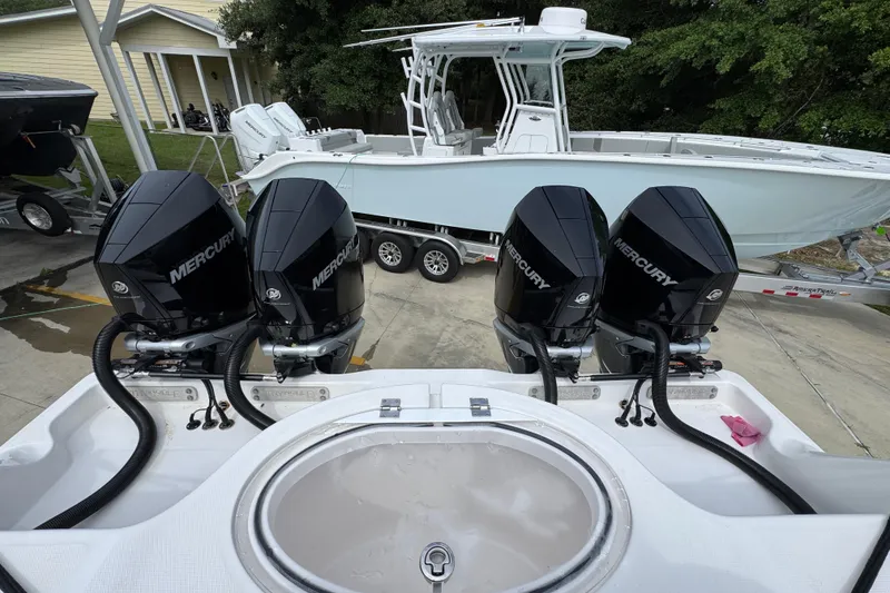 Slide: The Image of Four Mercury outboard engines on a 2020 Invincible 35 Catamaran, parked on a trailer. - 43