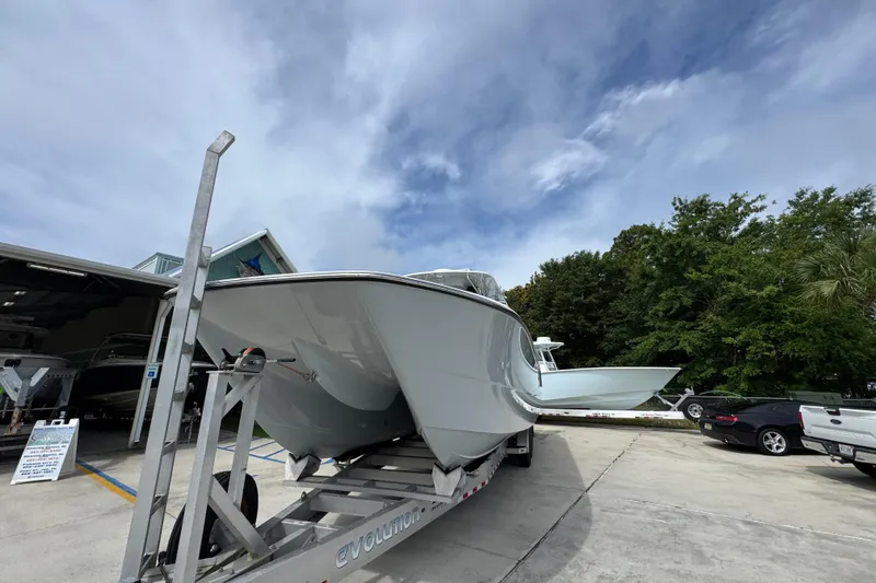 Slide: The Image of 2020 Invincible 35 Catamaran on trailer, parked outdoors under cloudy sky. - 5