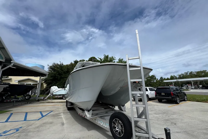 Slide: The Image of 2020 Invincible 35 Catamaran on trailer, parked outdoors under cloudy sky. - 7
