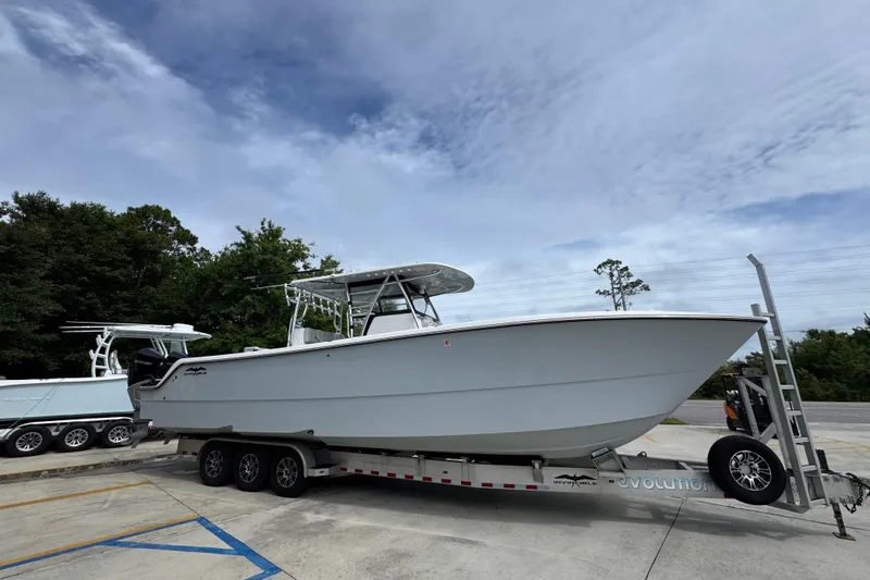 Slide: The Image of 2020 Invincible 35 Catamaran on trailer, parked outdoors under cloudy sky. - 9
