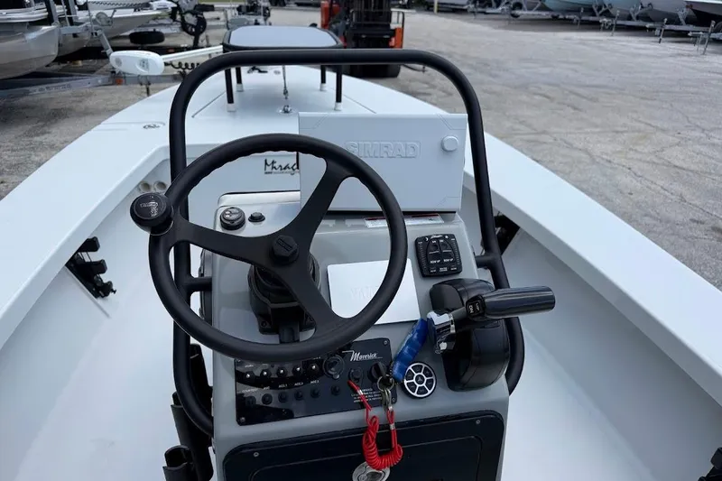 Slide: The Image of 2023 Maverick 18 HPX-V boat console with steering wheel and controls. - 16