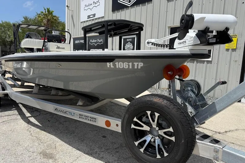 Slide: The Image of 2023 Maverick 18 HPX-V boat on trailer, parked outside a marine shop. - 4