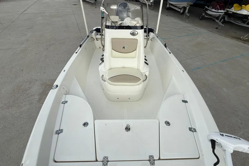 Slide: The Image of 2017 NauticStar 1910 NauticBay boat interior with seating and storage compartments. - 10