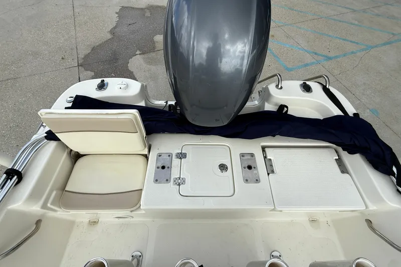Slide: The Image of 2017 NauticStar 1910 NauticBay boat stern with engine and seating area. - 12