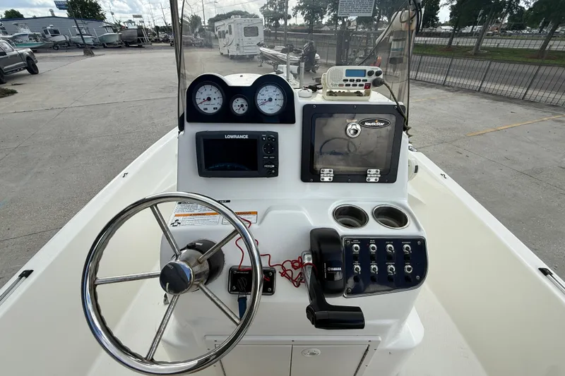 Slide: The Image of 2017 NauticStar 1910 NauticBay boat console with steering wheel and navigation equipment. - 13