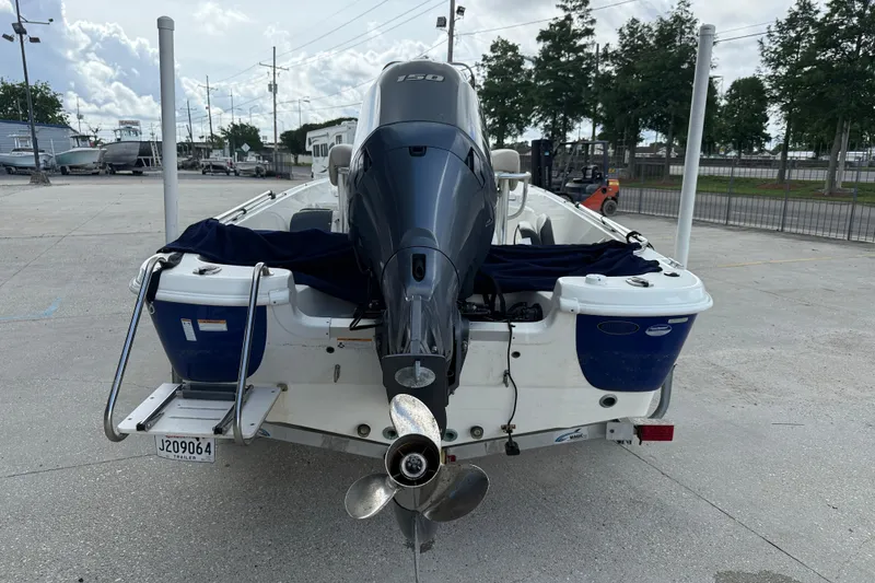 Slide: The Image of 2017 NauticStar 1910 NauticBay boat with powerful outboard motor, parked on concrete. - 5