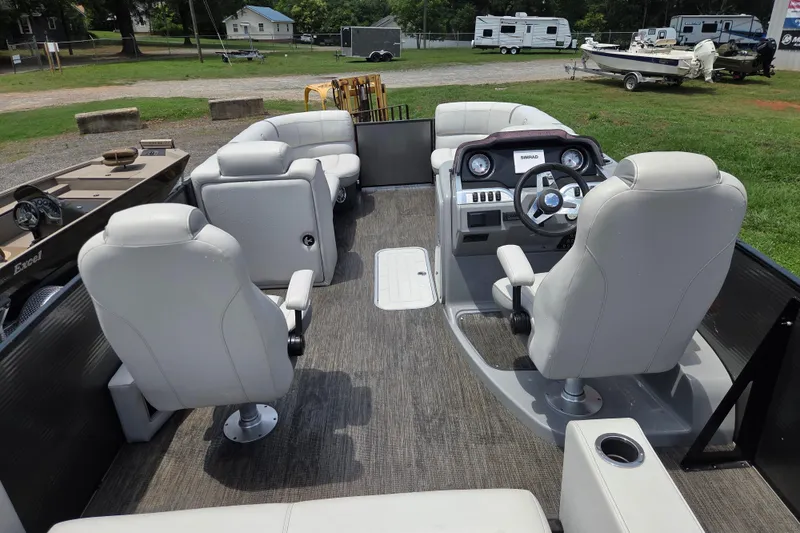 Slide: The Image of 2020 Godfrey AquaPatio 235 UL pontoon boat interior with plush seating and modern dashboard. - 13