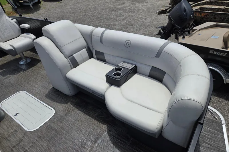 Slide: The Image of 2020 Godfrey AquaPatio 235 UL boat interior with plush seating and cup holders. - 18
