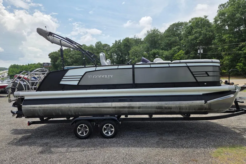 Slide: The Image of 2020 Godfrey AquaPatio 235 UL pontoon boat on trailer, parked outdoors. - 4