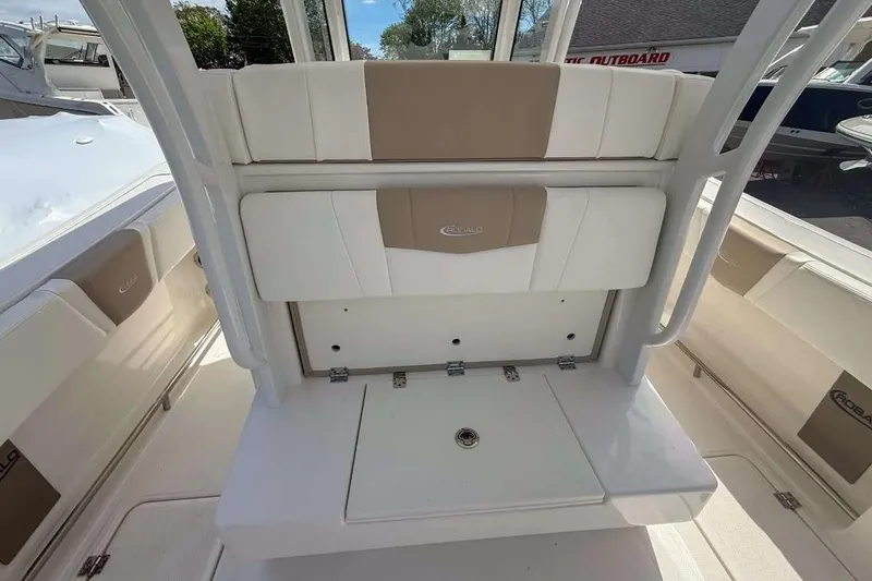 Slide: The Image of 2025 Robalo R270 Center Console boat interior with cushioned seating and storage area. - 4
