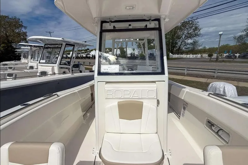 Slide: The Image of 2025 Robalo R270 Center Console boat with sleek design and spacious seating. - 8