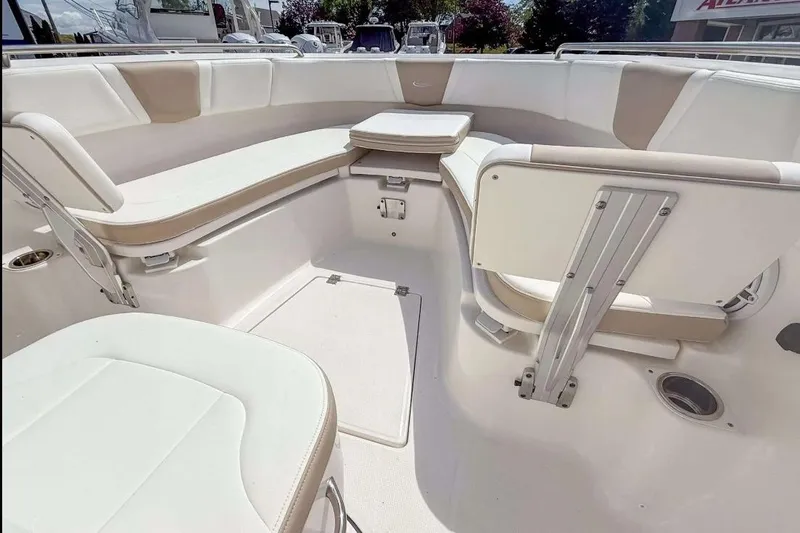 Slide: The Image of 2025 Robalo R270 Center Console boat interior with cushioned seating and modern design. - 9