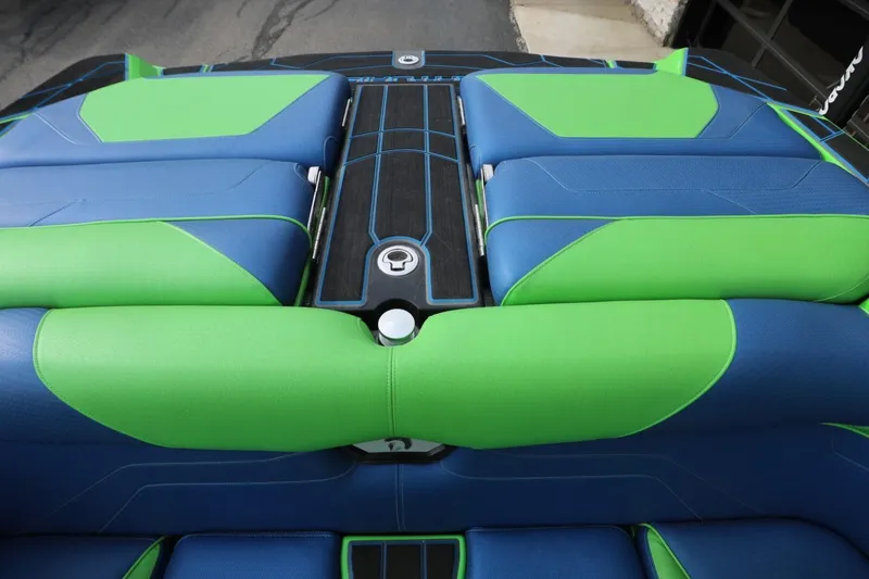 Slide: The Image of 2022 Centurion Ri265 boat interior with blue and green seating design. - 11