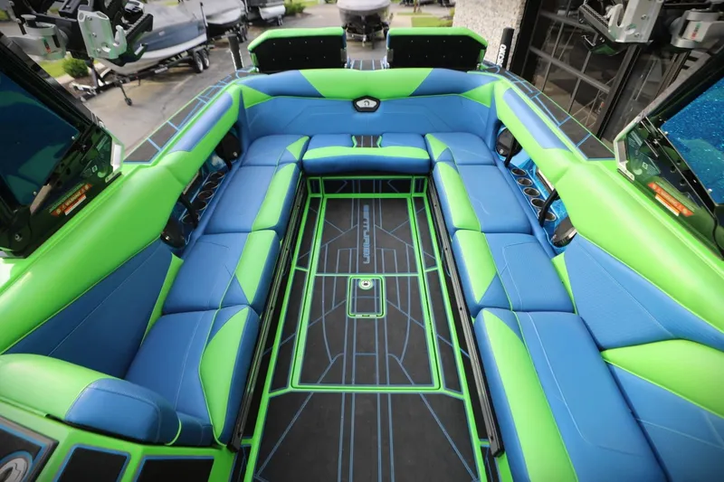 Slide: The Image of 2022 Centurion Ri265 boat interior with vibrant blue and green seating. - 5