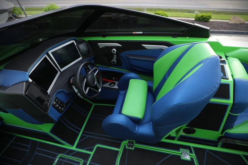 Slide: The Image of Interior of 2022 Centurion Ri265 boat with vibrant green and blue seating. - 6