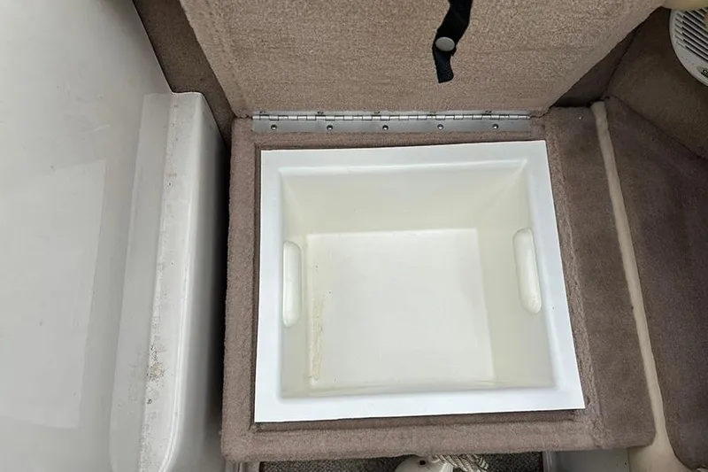 Slide: The Image of Storage compartment on a 2000 Sea Ray 230 Overnighter boat, featuring a white interior. - 10