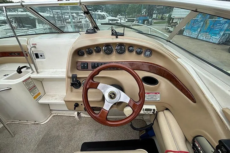 Slide: The Image of Interior view of a 2000 Sea Ray 230 Overnighter boat dashboard with steering wheel. - 14