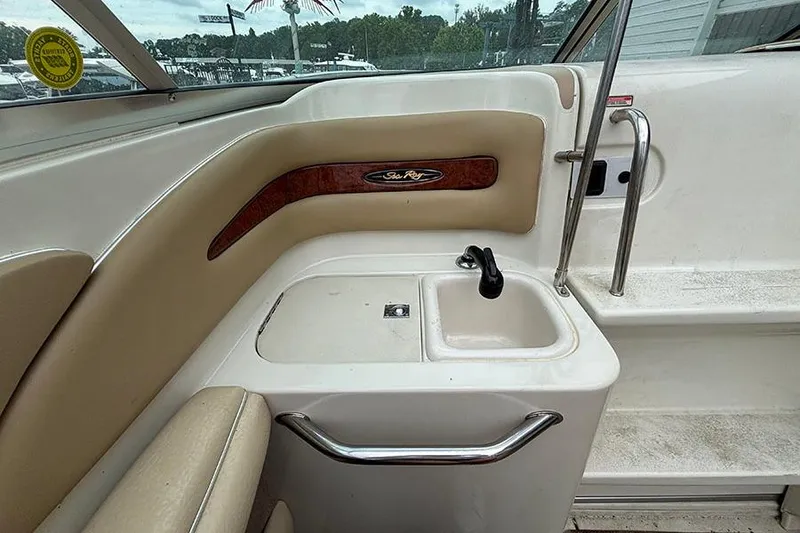 Slide: The Image of Interior view of a 2000 Sea Ray 230 Overnighter boat with sink and storage. - 17