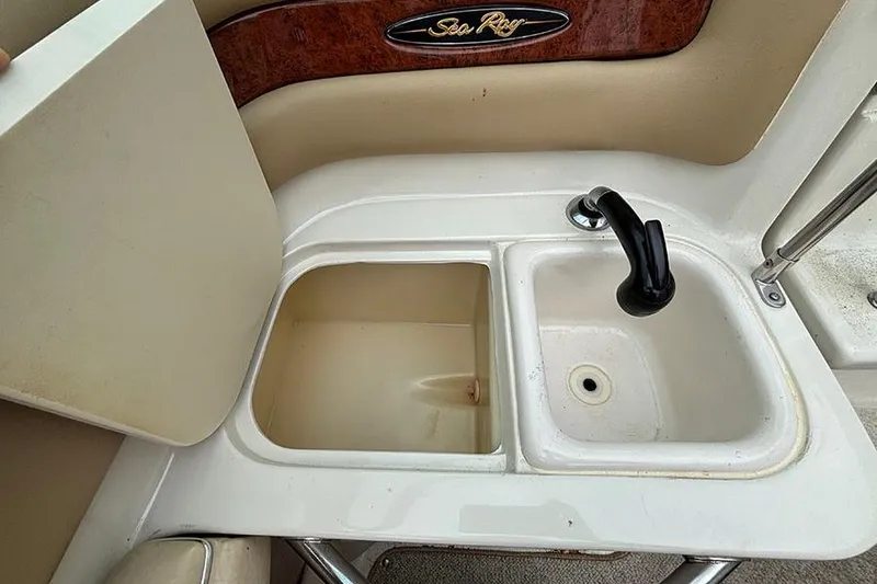 Slide: The Image of Sea Ray 230 Overnighter 2000 boat sink and storage compartment. - 18