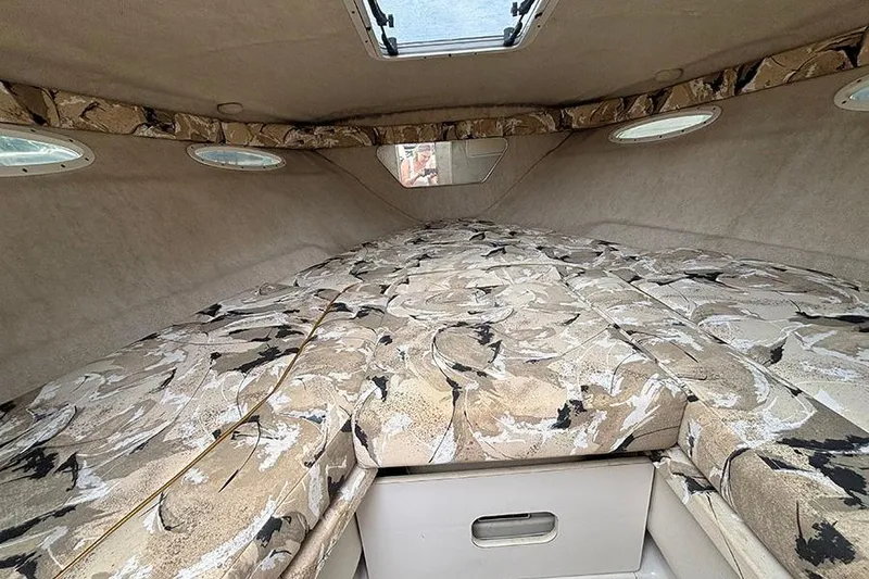Slide: The Image of Interior cabin of 2000 Sea Ray 230 Overnighter with patterned upholstery and storage. - 19