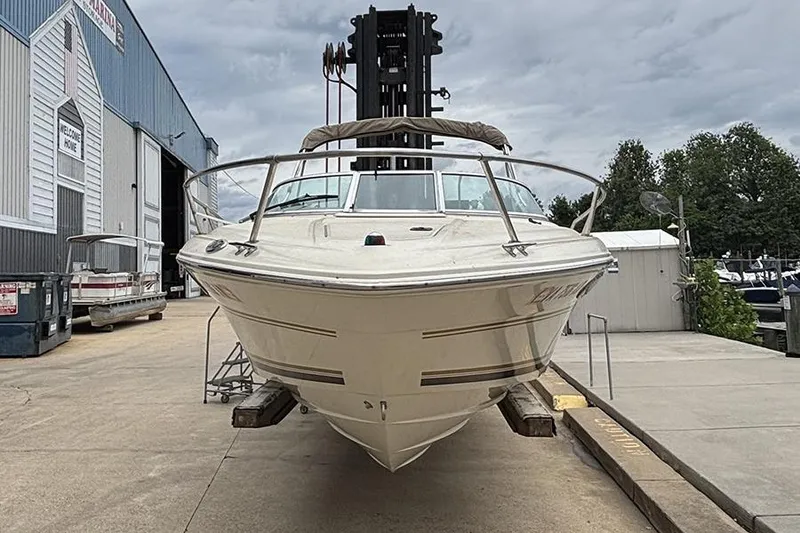 Slide: The Image of 2000 Sea Ray 230 Overnighter boat on a dock, front view. - 2