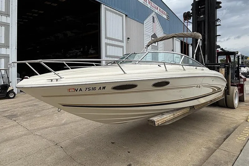 Slide: The Image of 2000 Sea Ray 230 Overnighter boat on forklift at marina. - 3