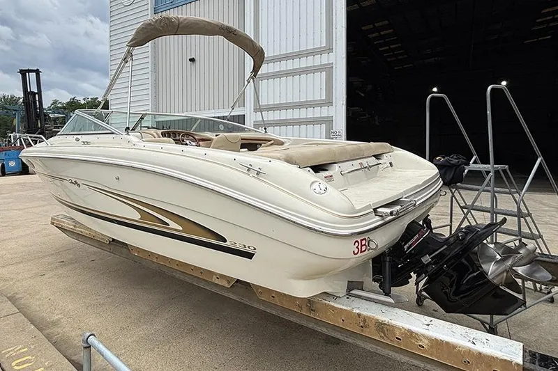 Slide: The Image of 2000 Sea Ray 230 Overnighter boat on trailer near storage facility. - 5