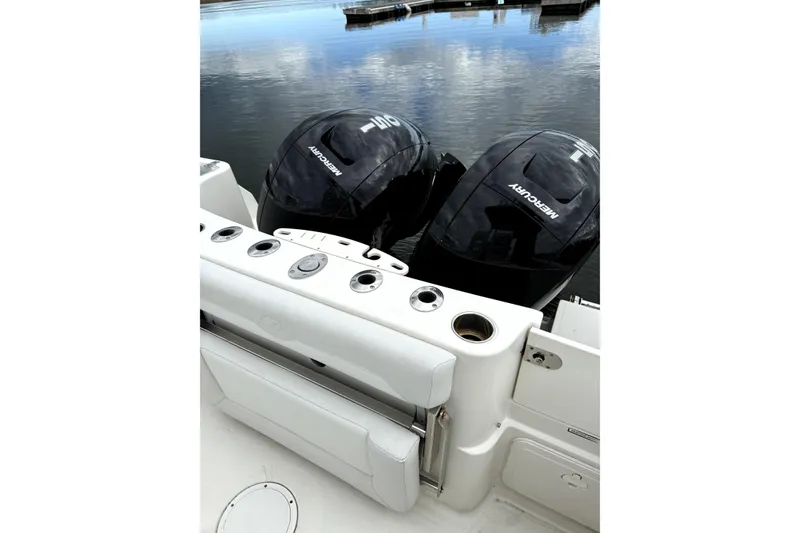 Slide: The Image of 2016 Sailfish 270 CC boat with dual Mercury outboard engines on calm water. - 2
