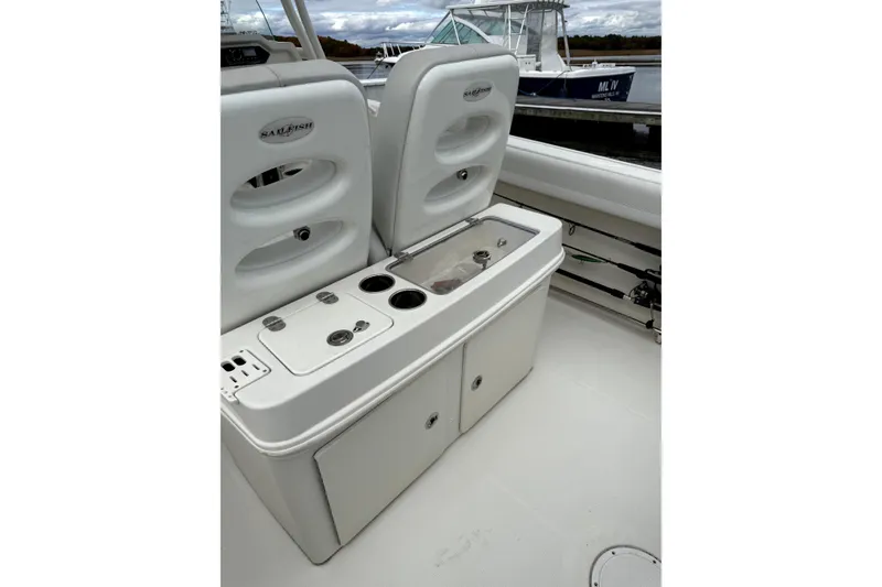 Slide: The Image of 2016 Sailfish 270 CC boat interior with storage compartments and seating. - 4