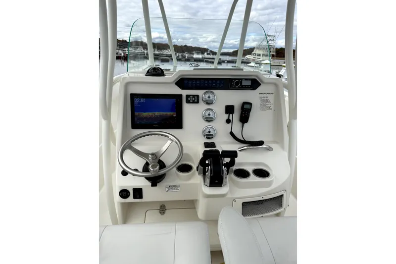 Slide: The Image of 2016 Sailfish 270 CC boat dashboard with steering wheel, gauges, and navigation screen. - 5