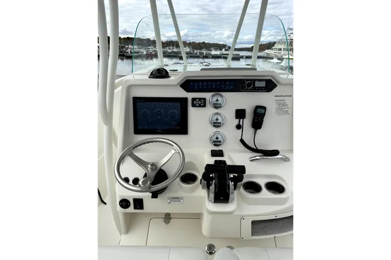 Slide: The Image of 2016 Sailfish 270 CC boat dashboard with steering wheel and navigation controls. - 8