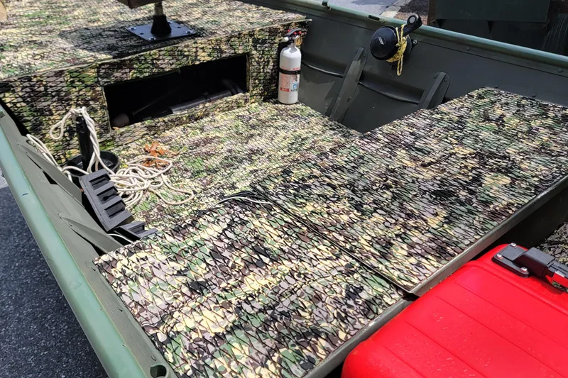 Slide: The Image of 1994 Alumacraft 1436 Jon boat interior with camouflage pattern and safety equipment. - 8