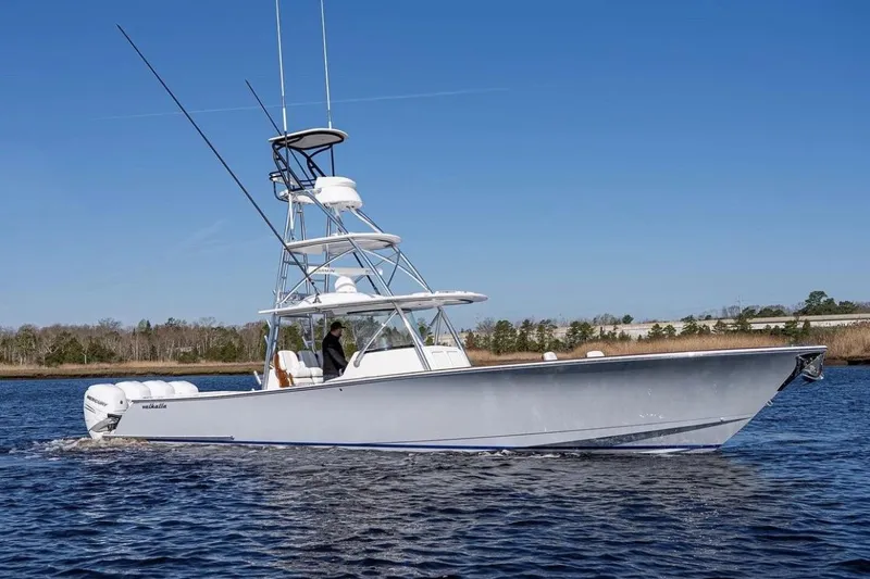 The Image of 2022 Valhalla Boatworks V-41 cruising on a calm waterway under clear blue skies. - 0