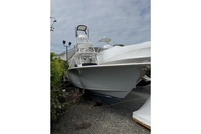 Slide: The Image of 2022 Valhalla Boatworks V-41, sleek design, parked outdoors on gravel. - 11