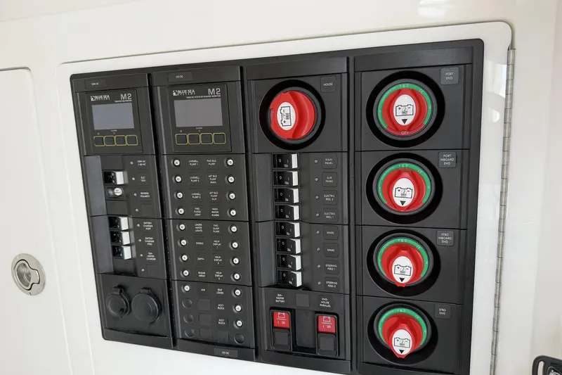 Slide: The Image of Electrical control panel on a 2022 Valhalla Boatworks V-41, featuring switches and gauges. - 18