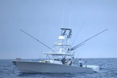 Slide: The Image of 2022 Valhalla Boatworks V-41 fishing boat on open sea, equipped with fishing rods. - 2