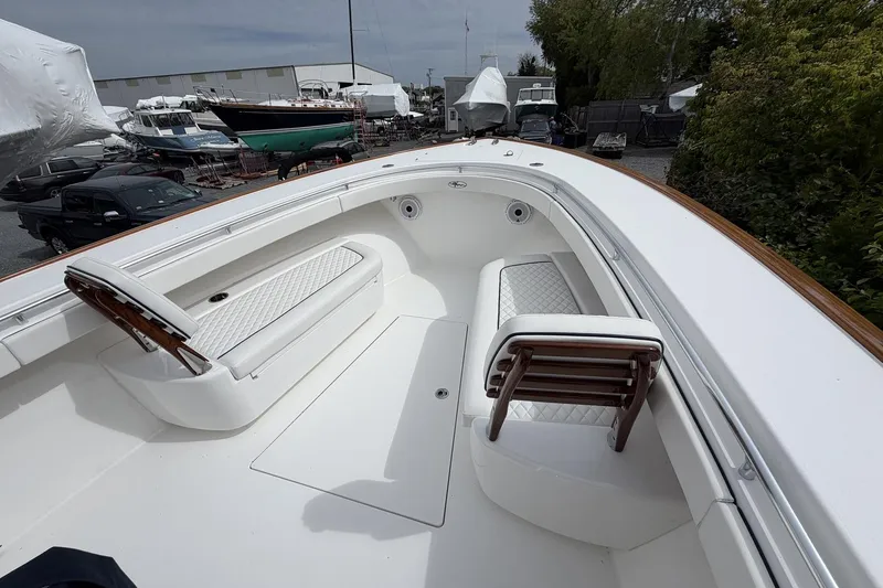 Slide: The Image of 2022 Valhalla Boatworks V-41 interior with white seating and wooden accents. - 22