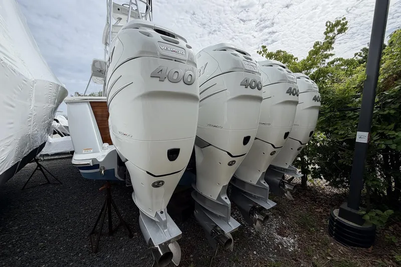 Slide: The Image of Four powerful outboard engines on a 2022 Valhalla Boatworks V-41, parked outdoors. - 5
