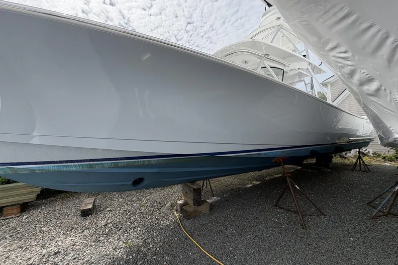 Slide: The Image of 2022 Valhalla Boatworks V-41 on stands, showcasing sleek hull design under cloudy sky. - 9