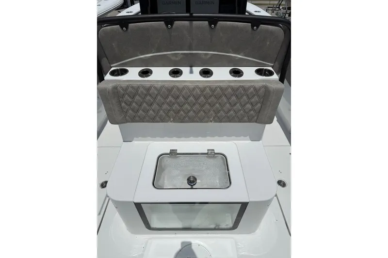 Slide: The Image of 2026 Sea Hunt Gamefish 27 Coffin Box interior with cushioned seating and cup holders. - 17