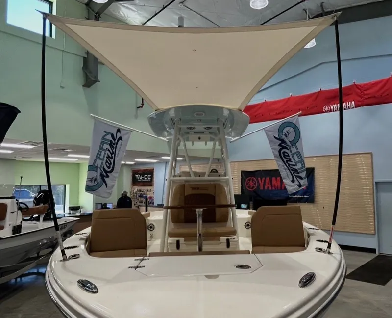 Slide: The Image of 2026 Pathfinder 2400 TRS boat in showroom with sunshade. - 17