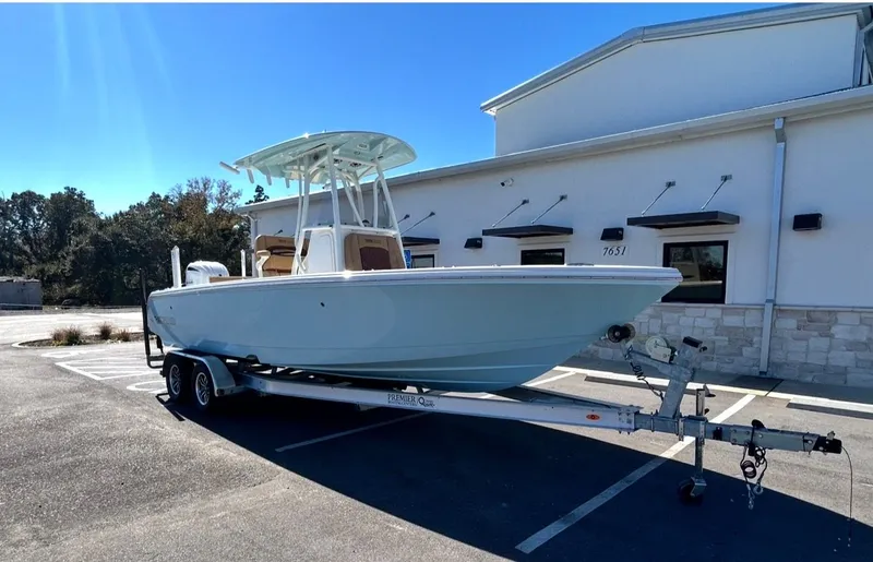 Slide: The Image of 2026 Pathfinder 2400 TRS boat on trailer in front of building. - 8