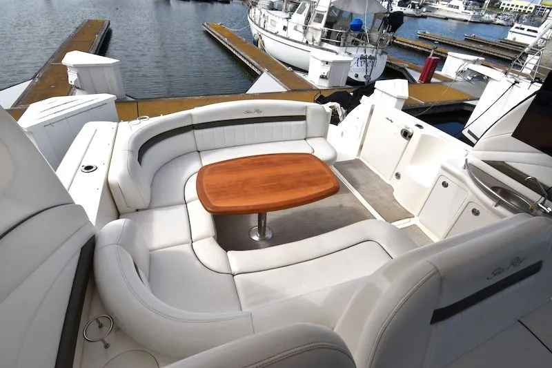 Slide: The Image of 2007 Sea Ray 40 Sundancer with elegant seating and wooden table at the marina. - 14