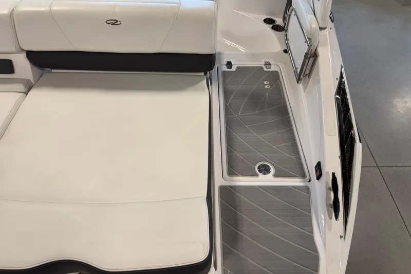 Slide: The Image of 2016 Regal 2550 Cuddy boat interior with cushioned seating and storage area. - 10
