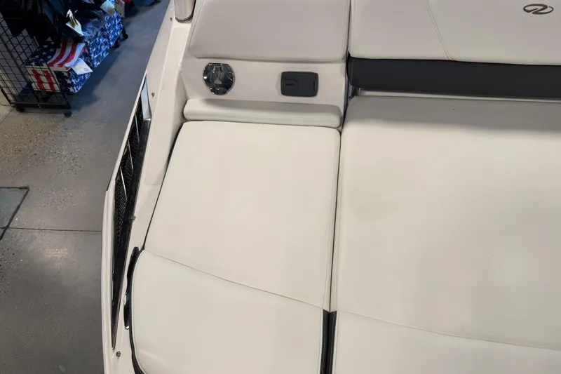 Slide: The Image of 2016 Regal 2550 Cuddy boat interior with white cushioned seating. - 11