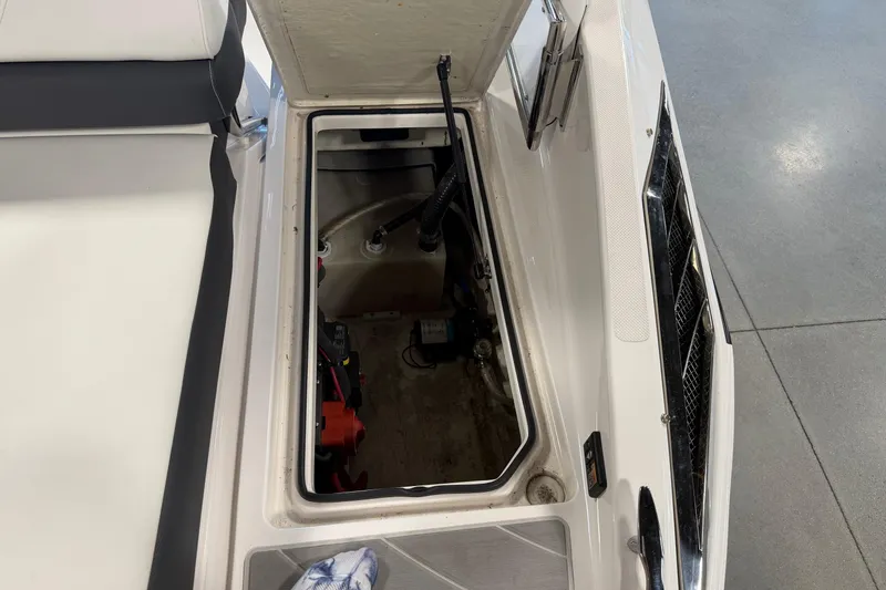 Slide: The Image of Open storage compartment in 2016 Regal 2550 Cuddy boat, showcasing interior details. - 12