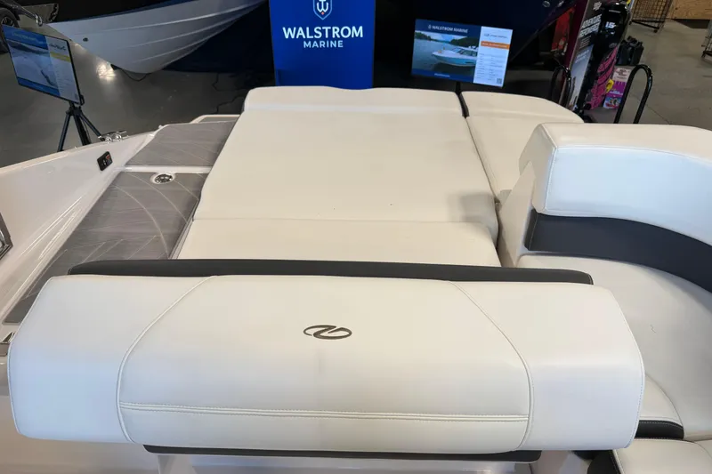 Slide: The Image of 2016 Regal 2550 Cuddy boat interior with white seating at Walstrom Marine showroom. - 14