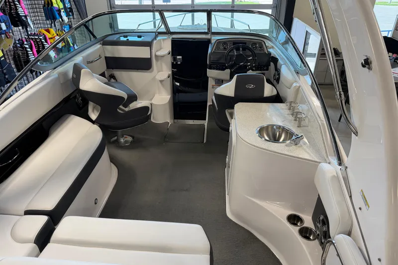 Slide: The Image of Interior of a 2016 Regal 2550 Cuddy boat with seating and helm. - 16